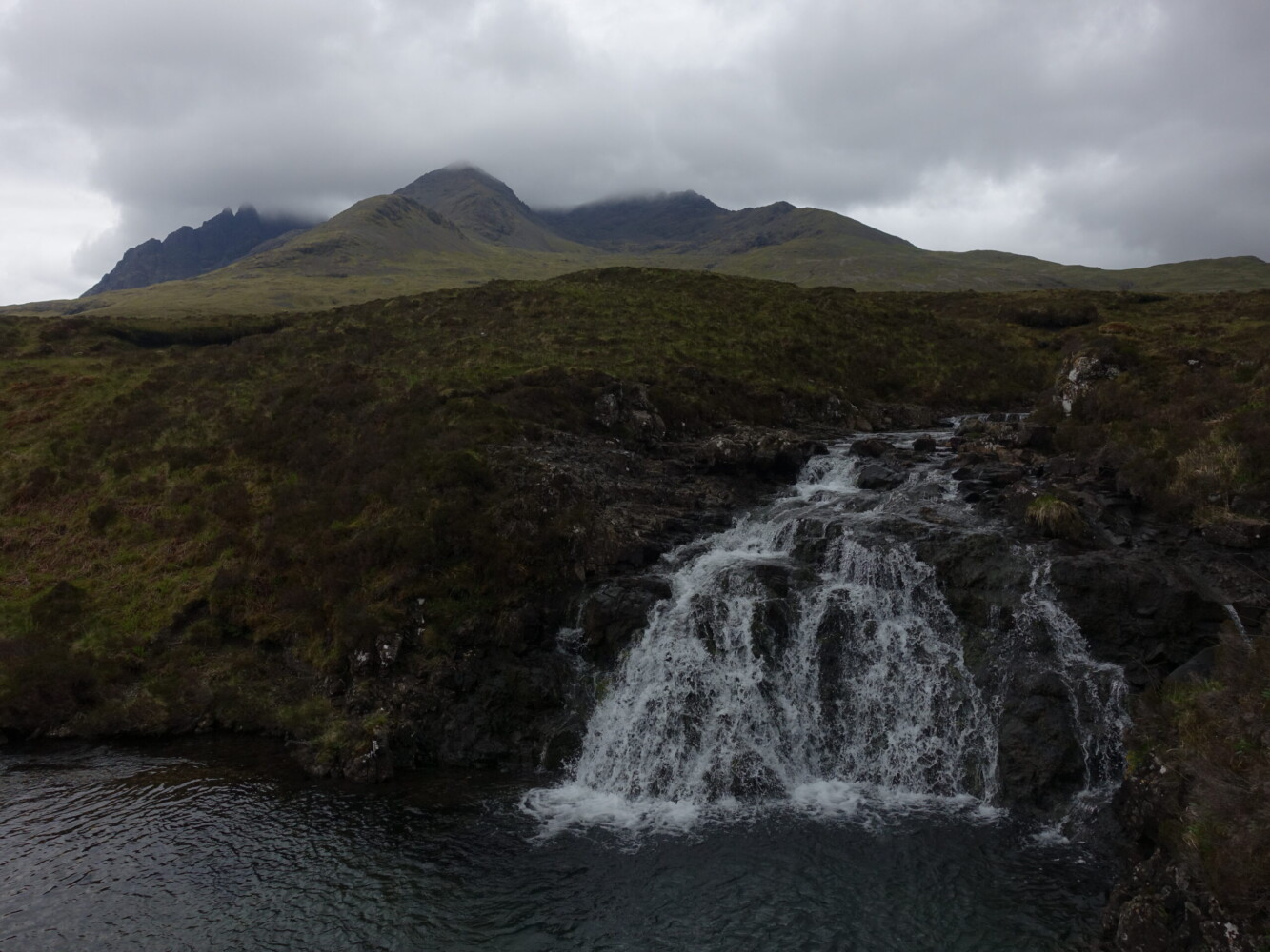 Oppressive weather gathering on the Cuillin Cuillin Ridge, covered by cloud. Viewd from Sligachan