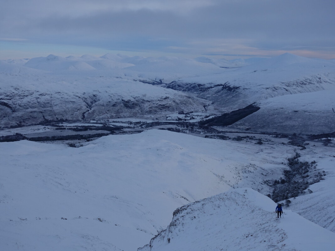 A rapidly dropping ceiling. We would shortly be fully in the cloud. Climber on Beinn Eighe
