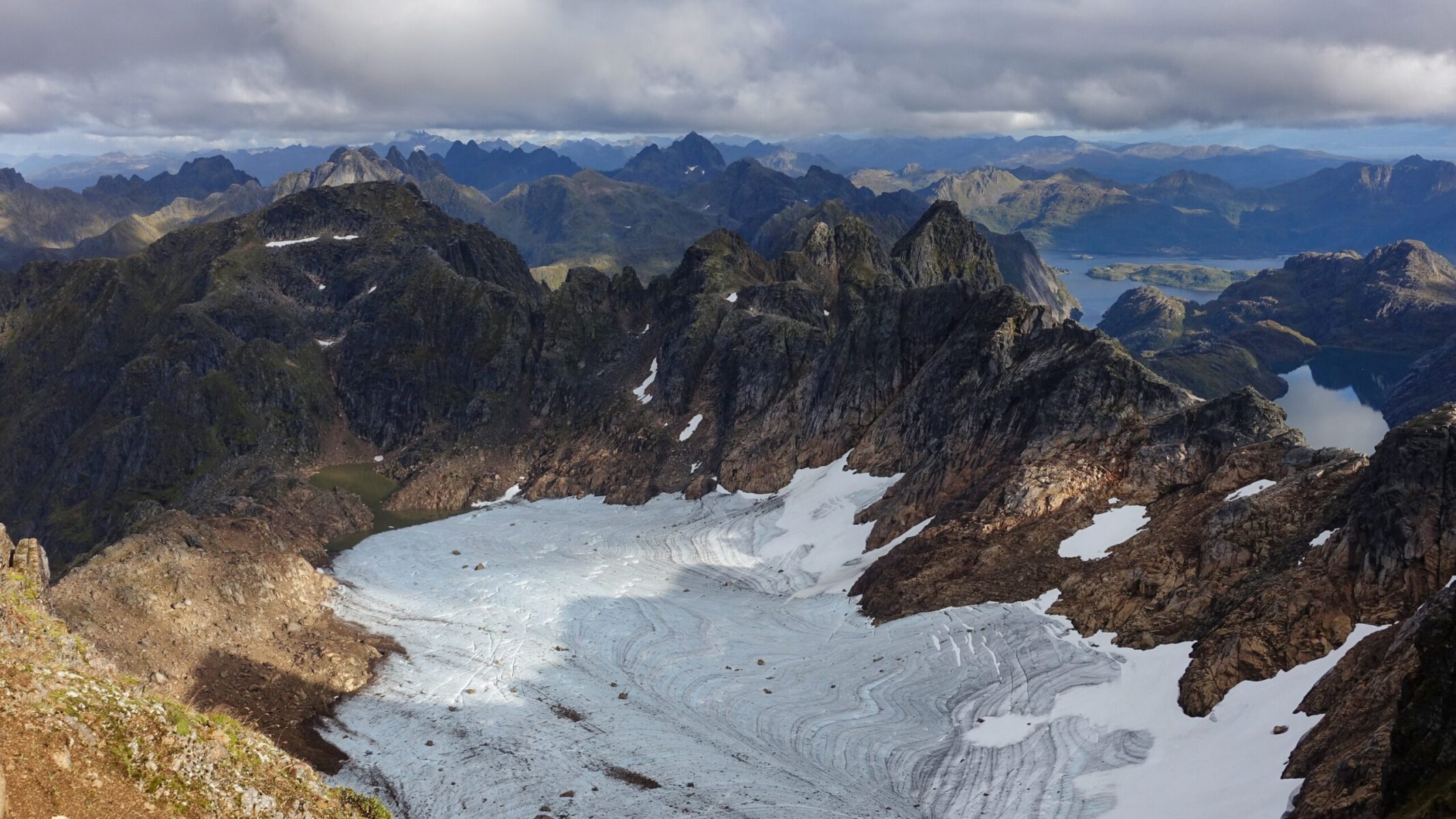 Trollfjorden: Norway's narrowest fjord (vertical channel on the right) Higravtind summit views