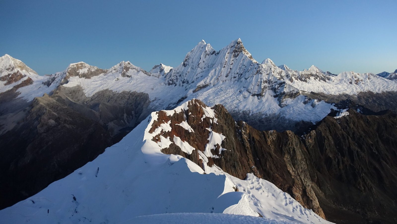 Summit views of the technical ridge and Chacraraju at first light Yanapaccha summit